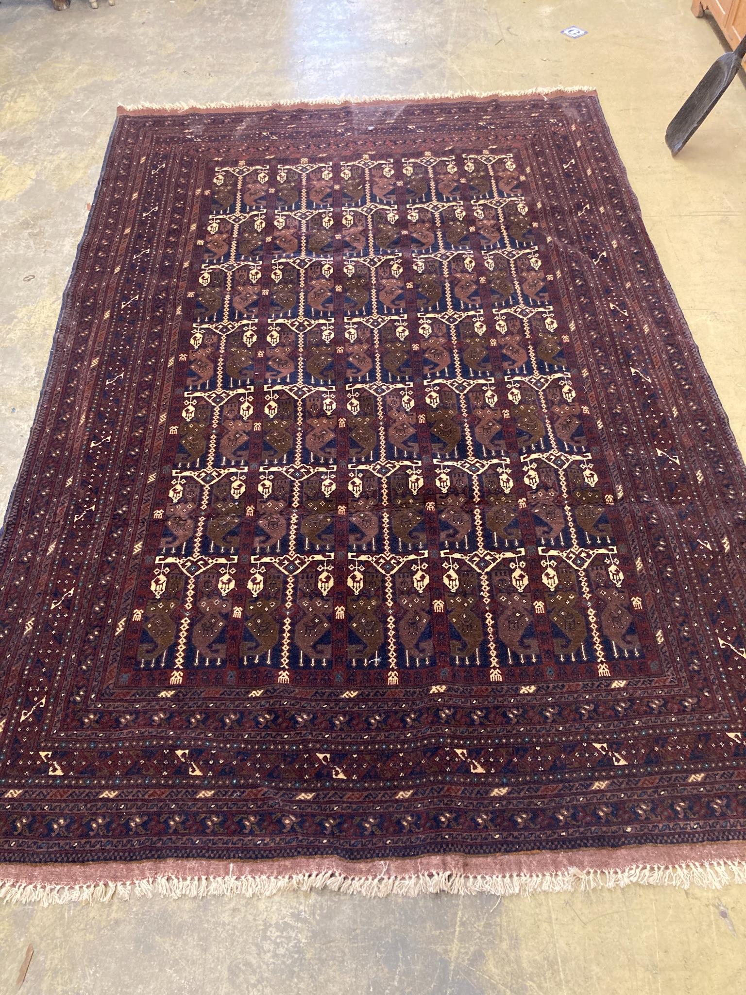 An Eastern dark red and blue ground carpet with central pole medallion within multi borders and guards, 306 x 204cm